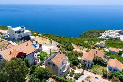 an aerial view of a house and the ocean at Penthouse apartment with panoramic oceanview in Krimovice