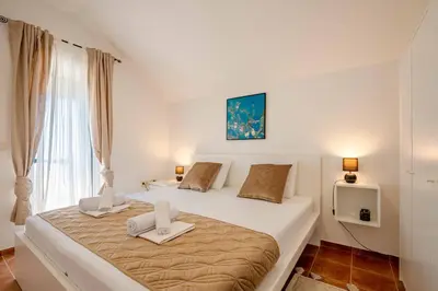 a bedroom with a bed with two towels on it at Penthouse apartment with panoramic oceanview in Krimovice