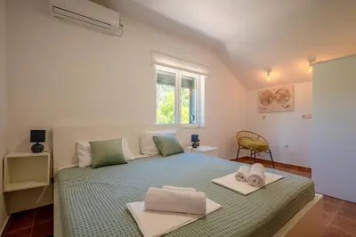 a bedroom with a bed with towels on it at Penthouse apartment with panoramic oceanview in Krimovice