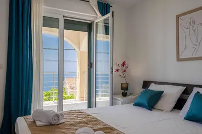 a bedroom with a bed with a view of the ocean at Vacation home in Budva with fantastic oceanview in Krimovice