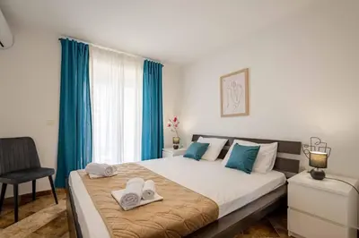 a bedroom with a large bed with towels on it at Vacation home in Budva with fantastic oceanview in Krimovice