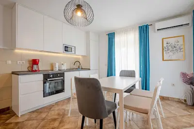 a kitchen and dining room with a table and chairs at Vacation home in Budva with fantastic oceanview in Krimovice