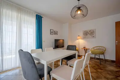 a dining room with a white table and chairs at Vacation home in Budva with fantastic oceanview in Krimovice