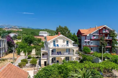 a large house on a hill with houses at Vacation home in Budva near the beach in Krimovice