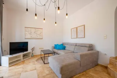 a living room with a couch and a tv at Vacation home in Budva near the beach in Krimovice