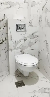 a white toilet in a bathroom with marble walls at Blue Skies in Podgorica