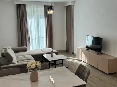 a living room with a couch and a tv at K apartments in Becici