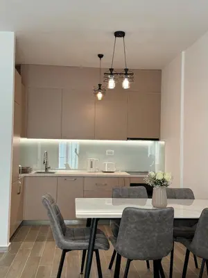 a kitchen with a table and chairs in a room at K apartments in Becici