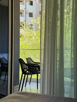 two chairs sitting in front of a window at K apartments in Becici