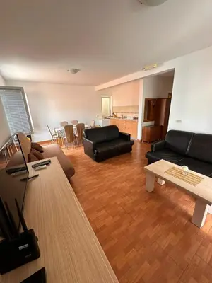 a living room with a black couch and a table at Apartments Djuro in Petrovac na Moru