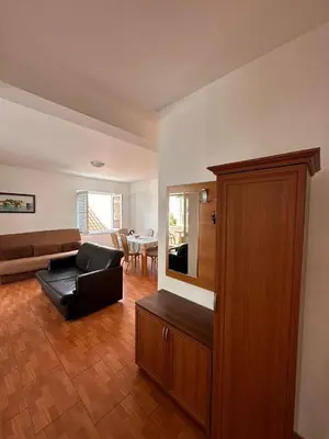 a living room with a couch and a chair at Apartments Djuro in Petrovac na Moru