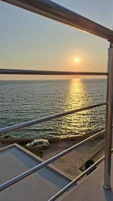 a car parked on a boat in the water at Apartmani Vila Delfin in Dobra Voda