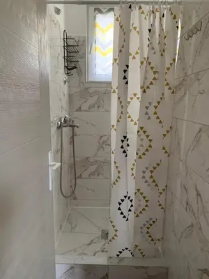 a bathroom with a shower with a shower curtain at Mariyka Apartaments 2 in Sutomore