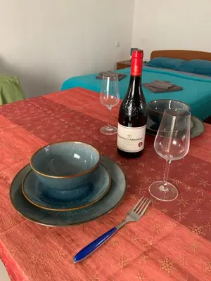 a table with a bottle of wine and two wine glasses at Mariyka Apartaments 2 in Sutomore