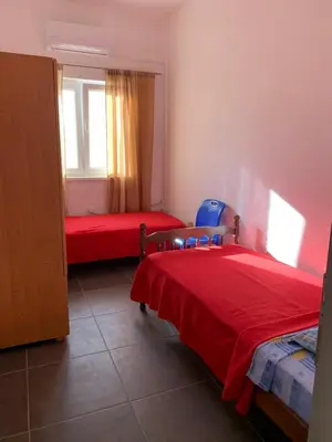 a bedroom with two beds and a window at Mariyka Apartaments 2 in Sutomore