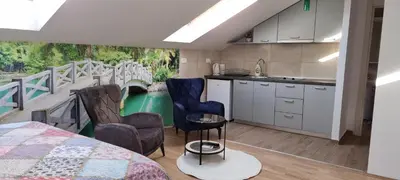 a kitchen with a balcony with a table and chairs at Nakiiii apartmanii in Podgorica