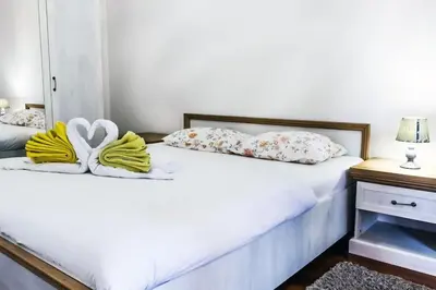 a bedroom with two beds with towels on them at Jasna's Old Town Apartment in Podgorica