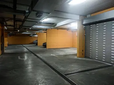 an empty parking garage with a bunch of doors at Jasna's Old Town Apartment in Podgorica