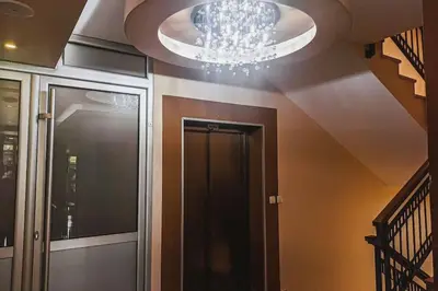a chandelier hanging from a ceiling in a hallway at Jasna's Old Town Apartment in Podgorica