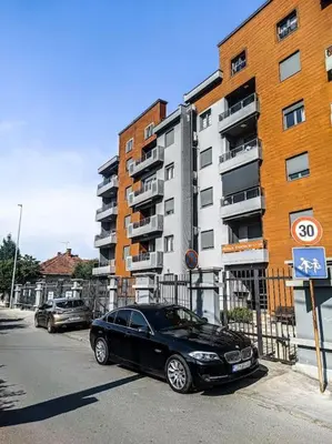 a black car parked on a street next to a building at Jasna's Old Town Apartment in Podgorica