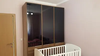 a large glass cabinet in a room with a crib at Holiday Home Kalicanin in Bar