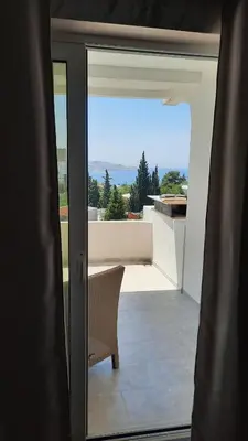 a door to a balcony with a view of the ocean at Holiday Home Kalicanin in Bar