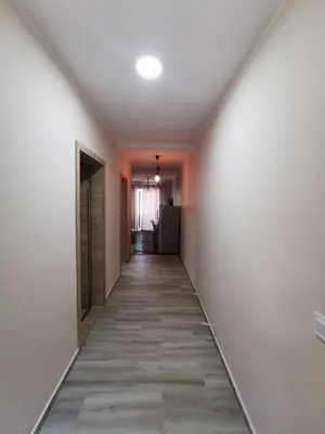 a hallway of an empty room with white walls and tile floors at Holiday Home Kalicanin in Bar