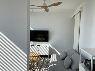 a living room with a couch and a ceiling fan at MiU Bar Apartment in Donji Susanj
