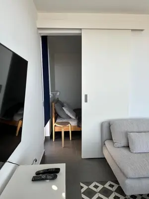a living room with a couch and a tv at MiU Bar Apartment in Donji Susanj