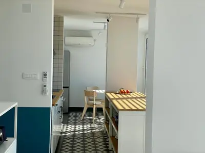 a kitchen with a counter and a table in a room at MiU Bar Apartment in Donji Susanj