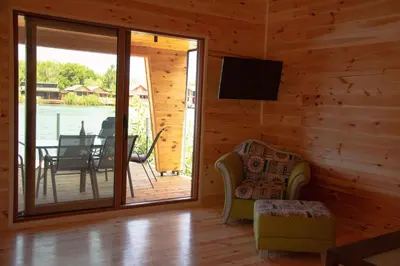 a living room with a screened in porch with a television at River house Bonaca in Ulcinj