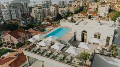 an aerial view of a building with a swimming pool at Infinity Hotel & More in Budva