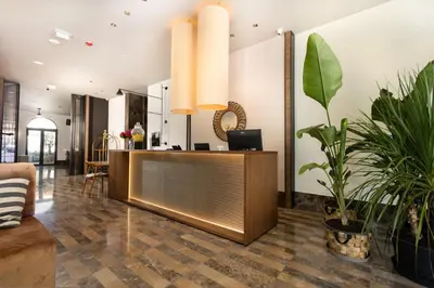 a lobby with a reception desk and potted plants at Infinity Hotel & More in Budva