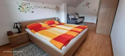 a bedroom with a bed with a colorful blanket at Schmidt in Lastva