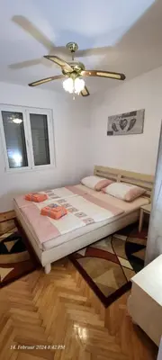 a bedroom with a bed and a ceiling fan at Schmidt in Lastva