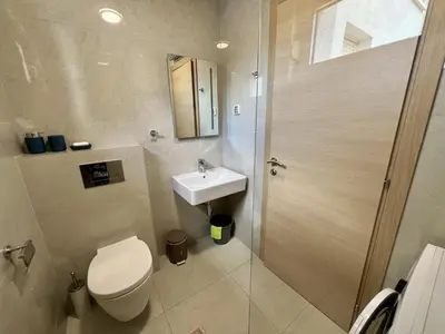 a bathroom with a toilet and a sink and a shower at Palma in Budva