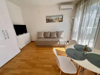 a living room with a table and a couch at Palma in Budva