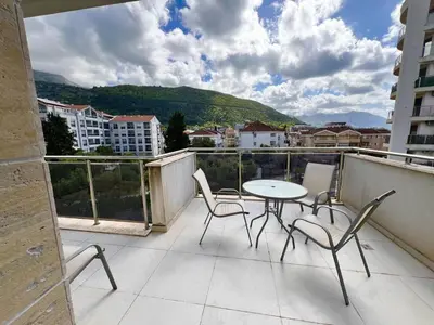 a patio with a table and chairs on a balcony at Palma in Budva
