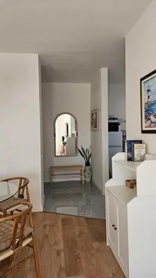 a living room with a table and a mirror at Monte View Apartments in Ulcinj