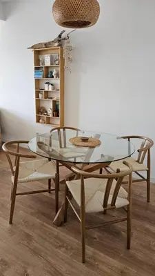 a glass table and two chairs and a table and a shelf at Monte View Apartments in Ulcinj