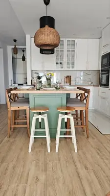 a kitchen with a blue island with chairs and a table at Monte View Apartments in Ulcinj