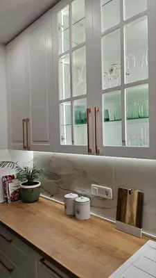 a kitchen with white cabinets and a wooden counter top at Monte View Apartments in Ulcinj