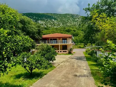 a house in the middle of a field with trees at STARS RESIDENCE in Petrovac na Moru