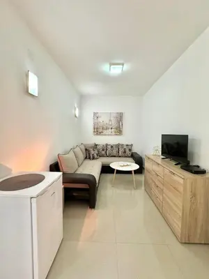 a living room with a couch and a tv at STARS RESIDENCE in Petrovac na Moru