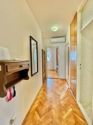 a room with a hallway with a wooden floor at Family two bedroom apartment Slavija in Budva