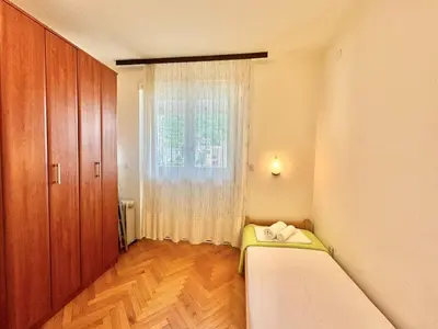 a small room with a bed and a window at Family two bedroom apartment Slavija in Budva