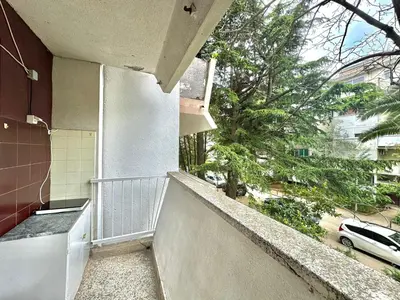 a balcony of a building with a view of a street at Family two bedroom apartment Slavija in Budva