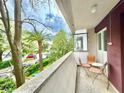 a balcony with two chairs and a table at Family two bedroom apartment Slavija in Budva