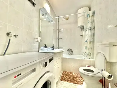 a white bathroom with a sink and a toilet at Family two bedroom apartment Slavija in Budva