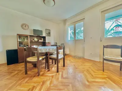 a dining room with a table and chairs at Family two bedroom apartment Slavija in Budva